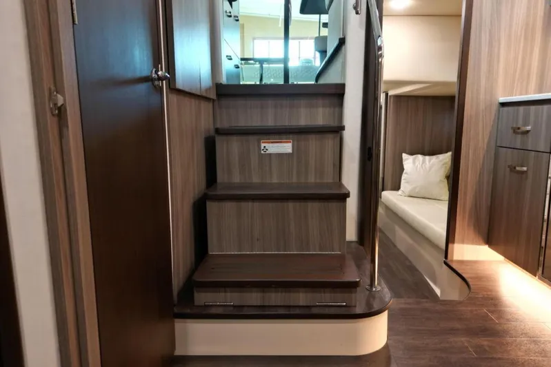  Yacht Photos Pics Interior of 2023 Regal 42 Fly yacht with wooden stairs and cozy cabin.