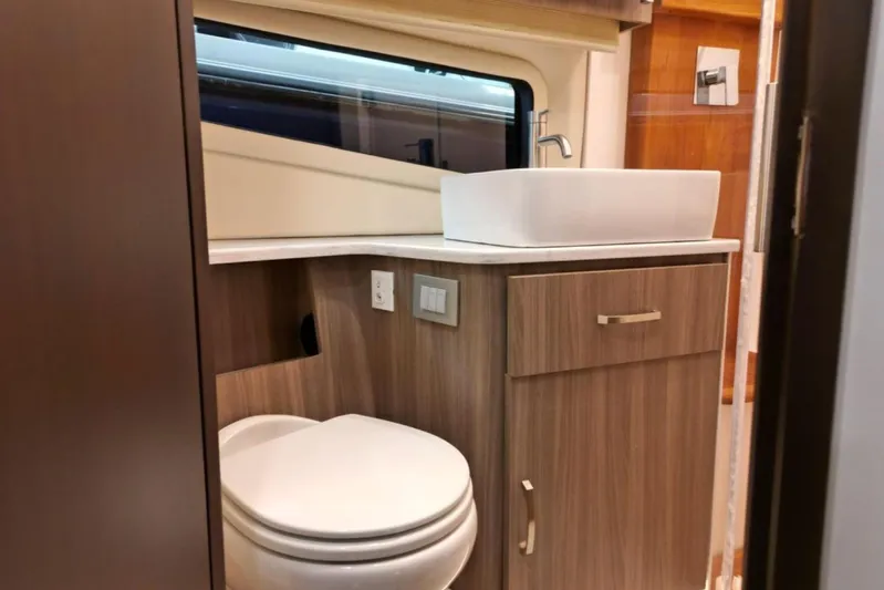  Yacht Photos Pics Modern bathroom interior of 2023 Regal 42 Fly yacht with sleek wood cabinetry.