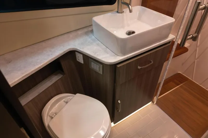  Yacht Photos Pics Modern bathroom interior of 2023 Regal 42 Fly yacht with sink and toilet.