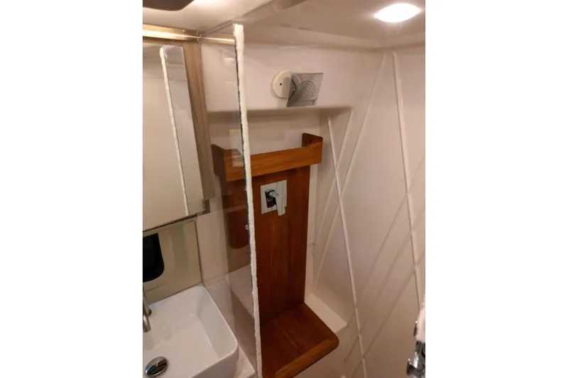  Yacht Photos Pics 2023 Regal 42 Fly yacht bathroom with modern sink and wooden accents.