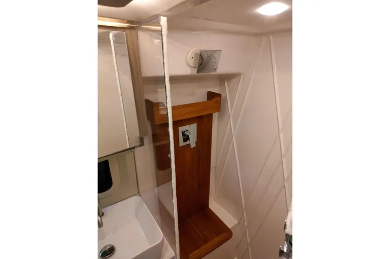  Yacht Photos Pics 2023 Regal 42 Fly yacht bathroom with modern sink and wooden accents.