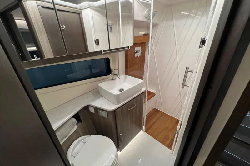  Yacht Photos Pics Luxurious bathroom interior of 2023 Regal 42 Fly yacht, featuring modern sink and shower.