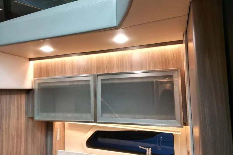  Yacht Photos Pics 2023 Regal 42 Fly yacht interior with modern wood cabinetry and ambient lighting.