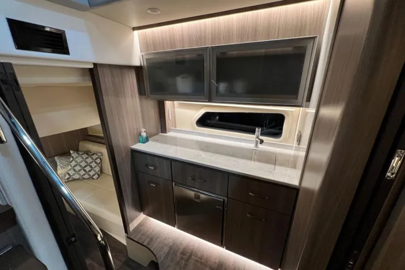  Yacht Photos Pics Luxurious interior of 2023 Regal 42 Fly yacht with modern kitchenette and cozy seating area.