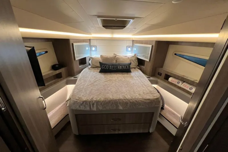  Yacht Photos Pics Luxurious 2023 Regal 42 Fly yacht bedroom with modern design and cozy lighting.