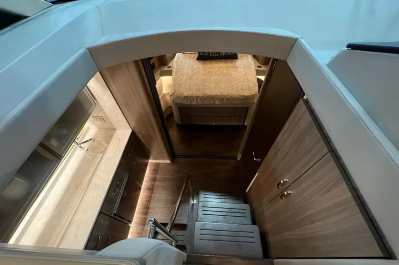  Yacht Photos Pics Interior view of 2023 Regal 42 Fly yacht, featuring stairs and a cozy cabin.