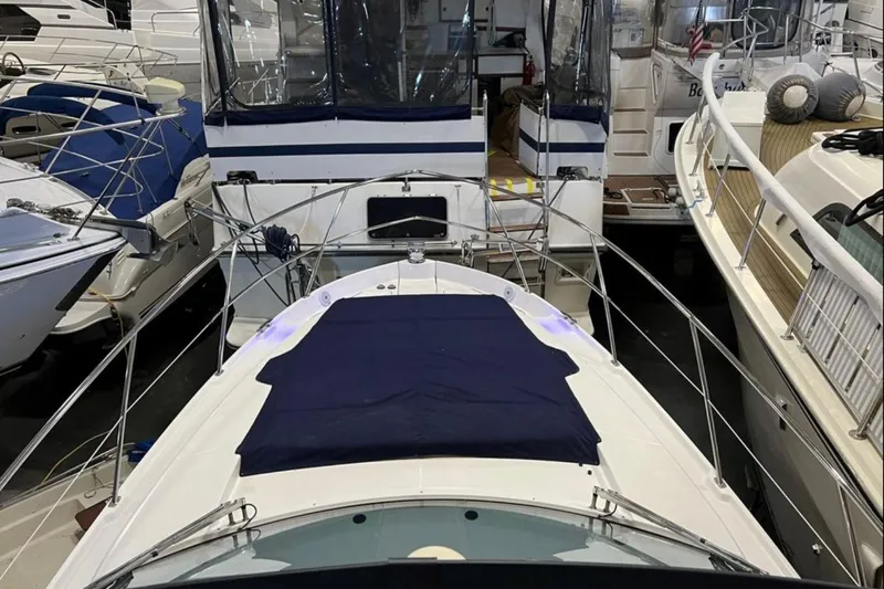  Yacht Photos Pics 2023 Regal 42 Fly yacht docked among other boats in a marina.