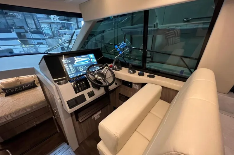  Yacht Photos Pics Luxurious helm of 2023 Regal 42 Fly yacht with modern controls and seating.