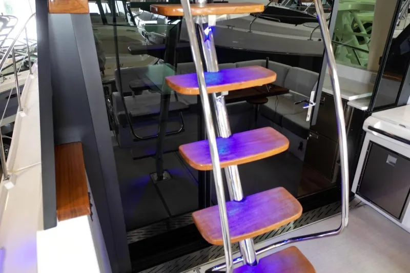  Yacht Photos Pics Staircase on 2023 Regal 42 Fly yacht with modern design and blue lighting.