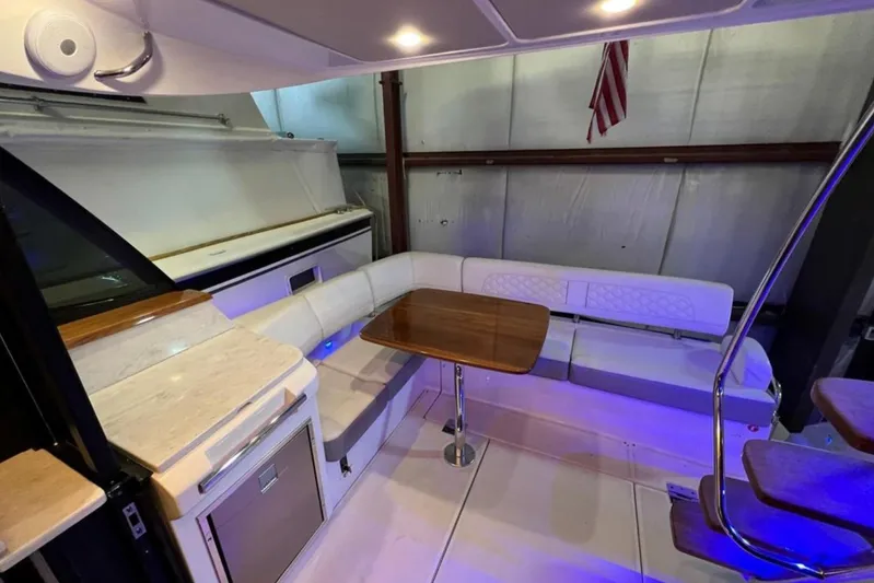  Yacht Photos Pics Luxurious interior of 2023 Regal 42 Fly yacht with elegant seating and wooden table.