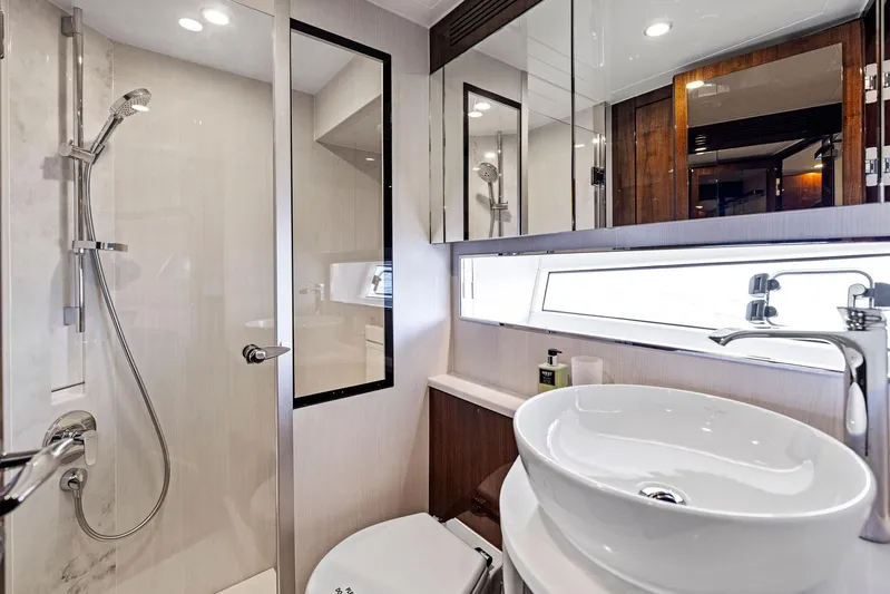  Yacht Photos Pics Luxurious bathroom in 2024 Fairline Squadron 68 yacht with modern fixtures and elegant design.