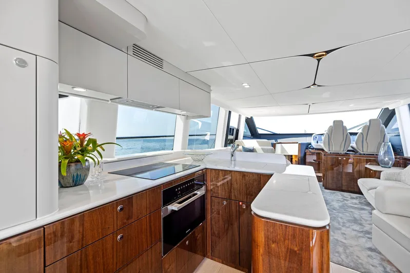  Yacht Photos Pics Luxurious interior of 2024 Fairline Squadron 68 yacht with modern kitchen and seating area.