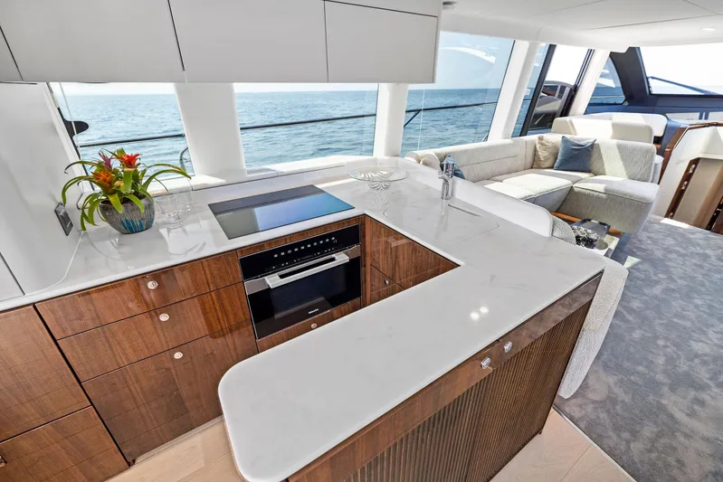 Yacht Photos Pics Luxurious interior of 2024 Fairline Squadron 68 yacht with modern kitchen and ocean view.