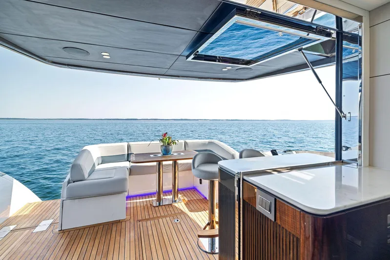  Yacht Photos Pics Luxurious 2024 Fairline Squadron 68 yacht interior with ocean view and modern seating area.