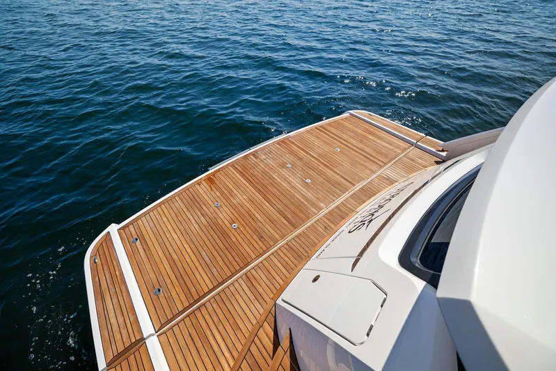  Yacht Photos Pics Fairline 2024 Squadron 68 yacht with teak deck on calm ocean water.