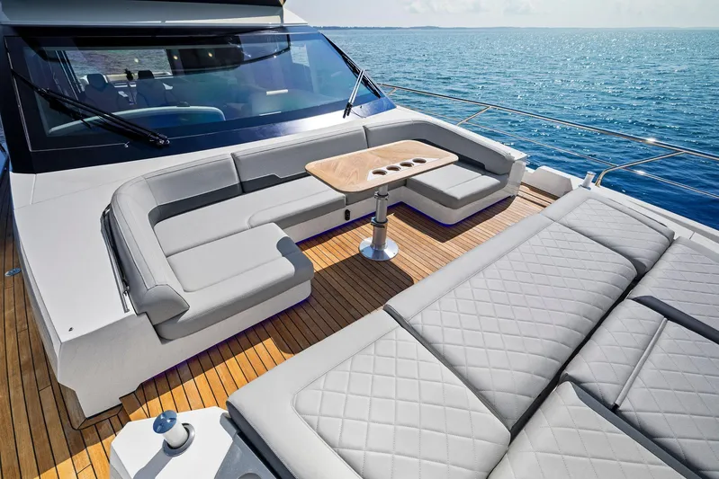  Yacht Photos Pics Luxury deck of 2024 Fairline Squadron 68 yacht with elegant seating and ocean view.