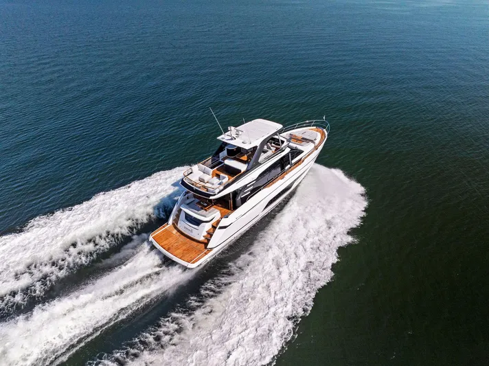  Yacht Photos Pics 2024 Fairline Squadron 68 yacht cruising on open water, aerial view.