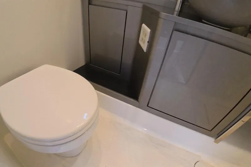  Yacht Photos Pics Modern bathroom in 2025 Schaefer V44 yacht with sleek cabinetry and toilet.