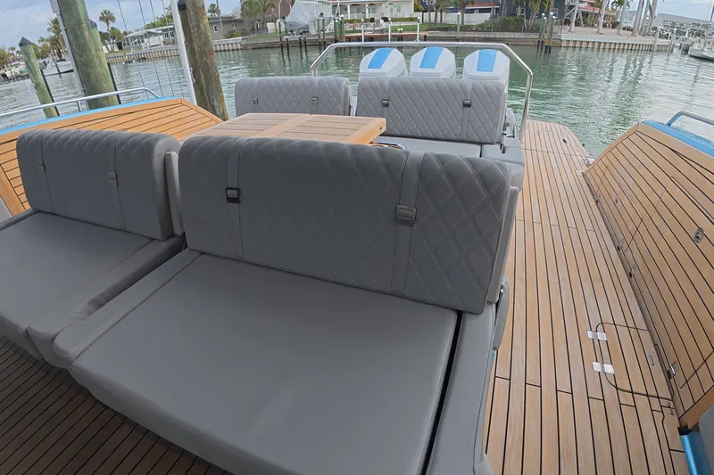 Yacht Photos Pics Luxury Schaefer V44 yacht deck with plush seating, 2025 model, docked by the water.