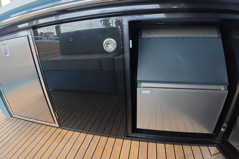  Yacht Photos Pics 2025 Schaefer V44 yacht interior with sleek cabinetry and modern appliances on wooden deck.