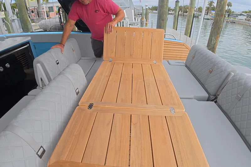  Yacht Photos Pics 2025 Schaefer V44 yacht with convertible teak table and cushioned seating.