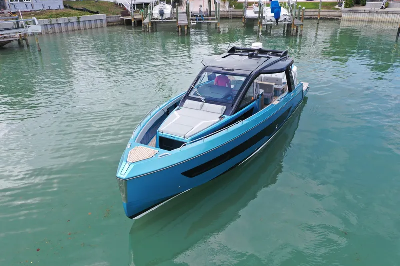  Yacht Photos Pics 2025 Schaefer V44 yacht in calm marina waters, showcasing sleek design and modern features.