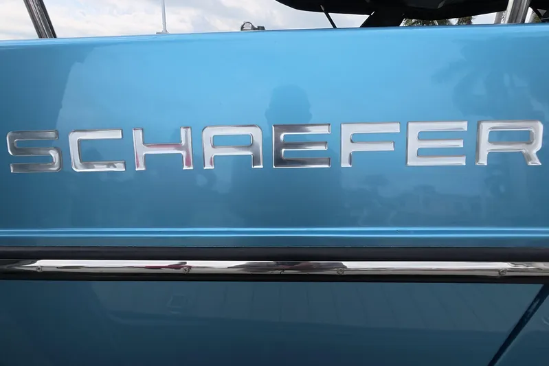  Yacht Photos Pics 2025 Schaefer V44 boat logo on a sleek blue surface.