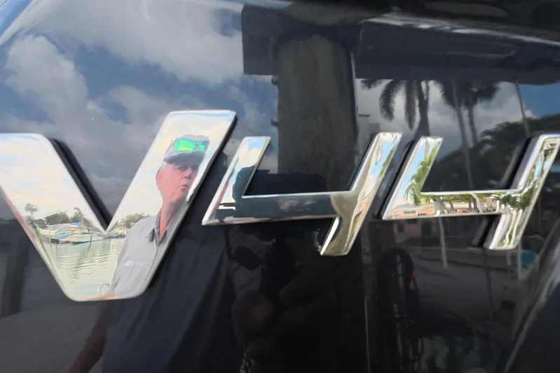  Yacht Photos Pics 2025 Schaefer V44 logo with reflection of marina and palm trees.