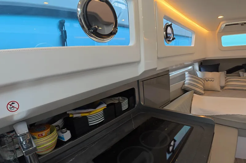 Yacht Photos Pics Interior of 2025 Schaefer V44 yacht with modern kitchen and cozy seating area.