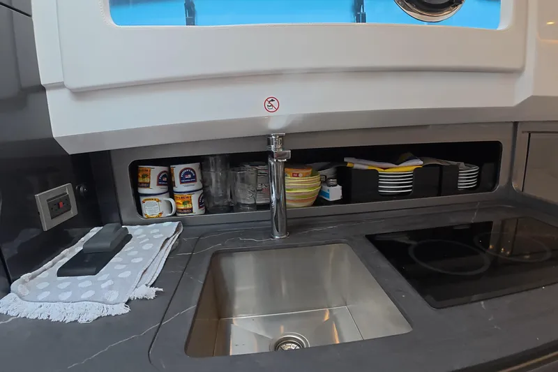  Yacht Photos Pics Modern kitchen sink area in 2025 Schaefer V44 yacht, featuring sleek design and storage.