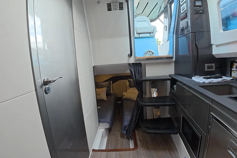  Yacht Photos Pics Interior of 2025 Schaefer V44 yacht featuring modern kitchen and cozy sleeping area.