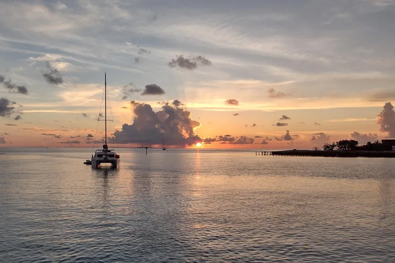 Lovely Cruise Yacht Photos Pics Catamaran sailing at sunset, Leopard 38 model, 2011, tranquil ocean view.