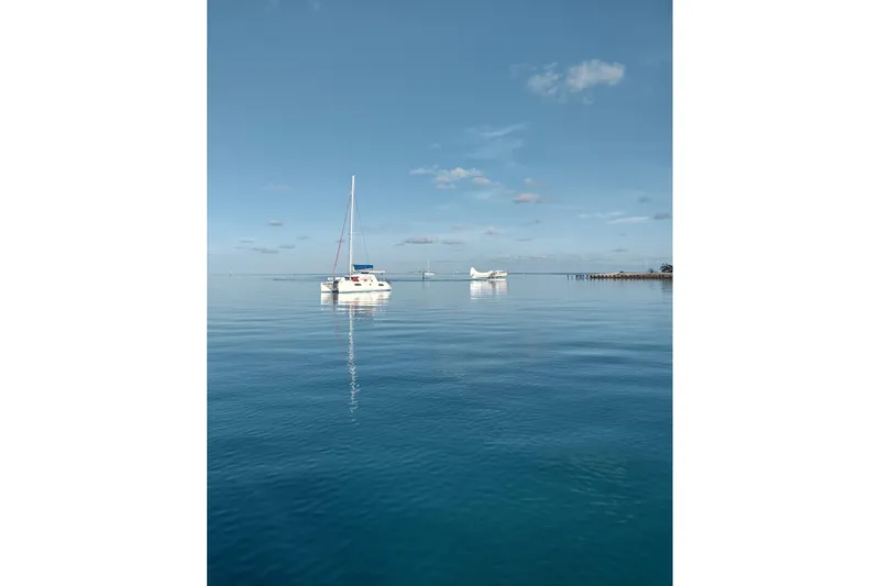 Lovely Cruise Yacht Photos Pics Sailboat on calm blue sea, clear sky, Leopard 38 model, 2011.