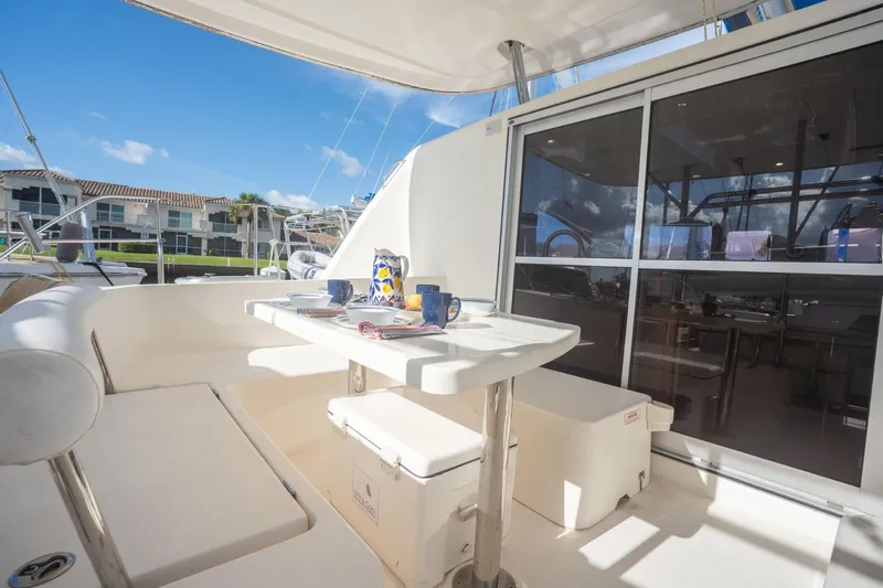 Lovely Cruise Yacht Photos Pics Outdoor seating area on 2011 Leopard 38 yacht with table set for dining.