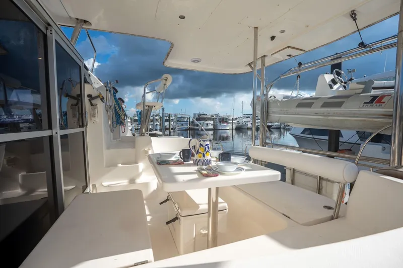 Lovely Cruise Yacht Photos Pics Outdoor seating area on a 2011 Leopard 38 yacht, docked at a marina.