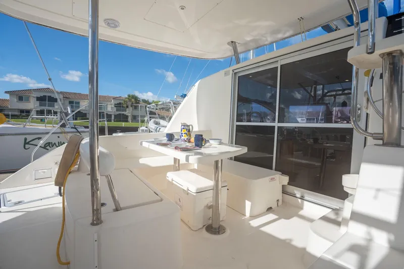Lovely Cruise Yacht Photos Pics Outdoor seating area on a 2011 Leopard 38 catamaran, featuring a table and chairs.