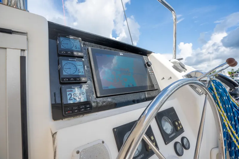 Lovely Cruise Yacht Photos Pics Control panel of a 2011 Leopard 38 yacht with navigation instruments and steering wheel.