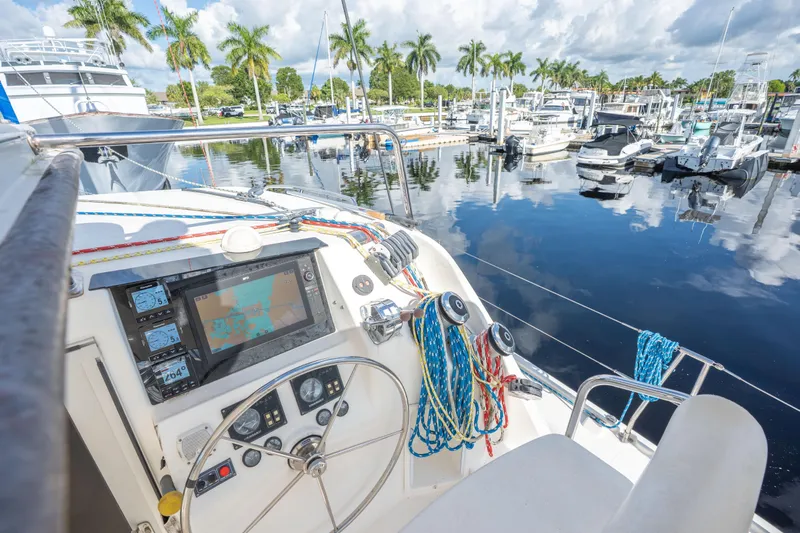 Lovely Cruise Yacht Photos Pics Cockpit view of 2011 Leopard 38 yacht at marina with palm trees and boats.