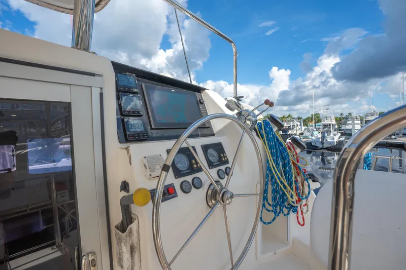 Lovely Cruise Yacht Photos Pics Steering wheel and controls of a 2011 Leopard 38 yacht at a marina.