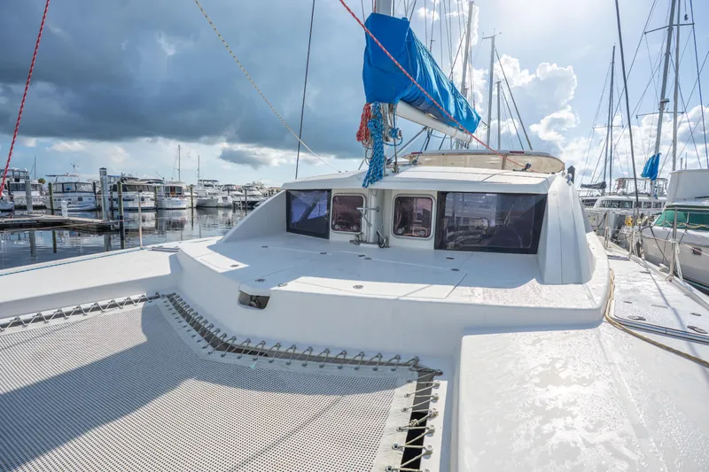 Lovely Cruise Yacht Photos Pics 2011 Leopard 38 catamaran docked at marina under cloudy sky.