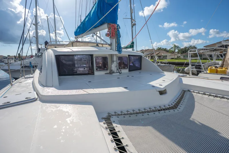 Lovely Cruise Yacht Photos Pics 2011 Leopard 38 catamaran docked, featuring spacious deck and blue sail under clear sky.