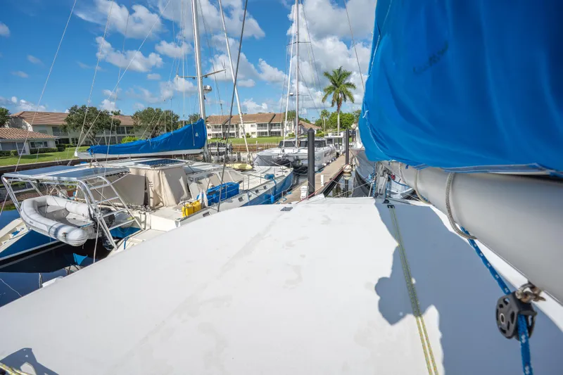 Lovely Cruise Yacht Photos Pics 2011 Leopard 38 catamaran docked, featuring blue sail covers and marina backdrop.