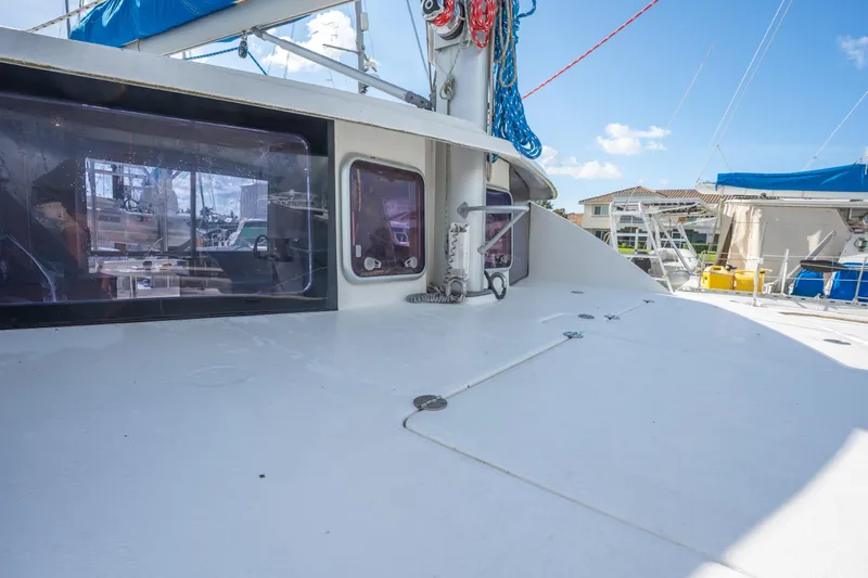 Lovely Cruise Yacht Photos Pics 2011 Leopard 38 catamaran deck with windows, ropes, and marina view.