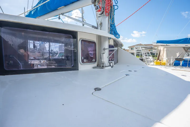 Lovely Cruise Yacht Photos Pics 2011 Leopard 38 catamaran deck with blue sail, marina view, and clear sky.