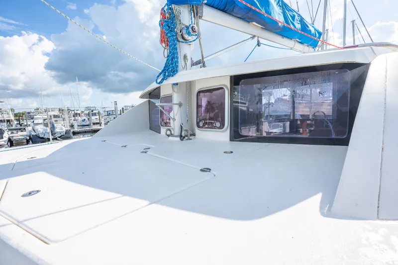 Lovely Cruise Yacht Photos Pics 2011 Leopard 38 catamaran deck with blue sail, docked at marina under cloudy sky.