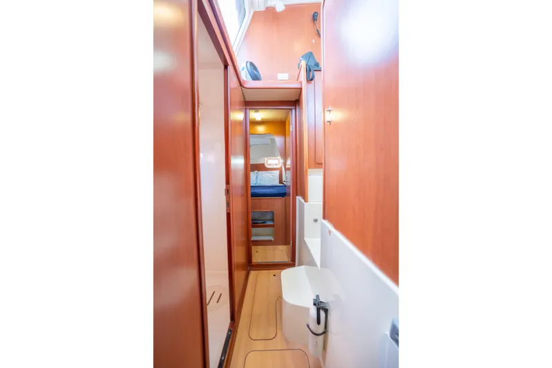 Lovely Cruise Yacht Photos Pics Interior of 2011 Leopard 38 yacht, featuring a compact bathroom and wooden cabinetry.