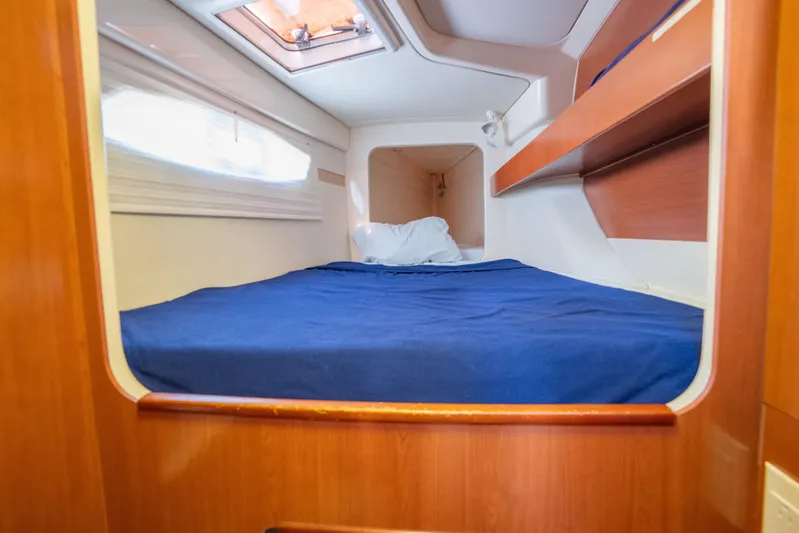 Lovely Cruise Yacht Photos Pics Cozy cabin interior of 2011 Leopard 38 yacht with blue bedding and wooden accents.