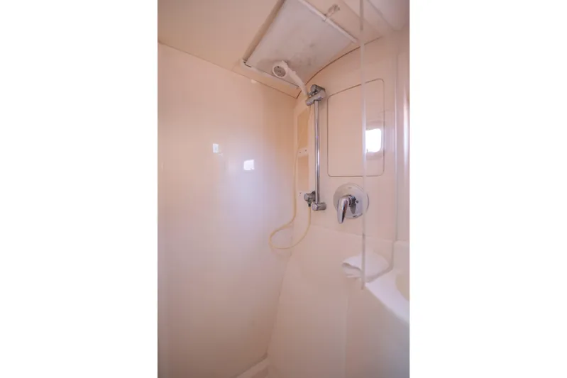 Lovely Cruise Yacht Photos Pics Compact shower area in a 2011 Leopard 38 yacht, featuring a handheld showerhead.