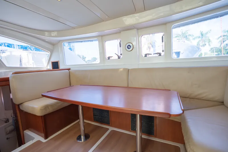 Lovely Cruise Yacht Photos Pics Interior of 2011 Leopard 38 yacht with spacious seating and wooden table.