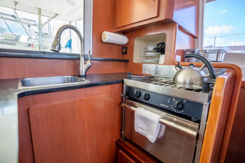 Lovely Cruise Yacht Photos Pics Compact kitchen in a 2011 Leopard 38 yacht with stove, sink, and kettle.